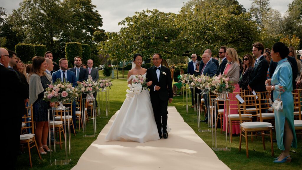 a bride and father walking down the aisle at monkey island estate